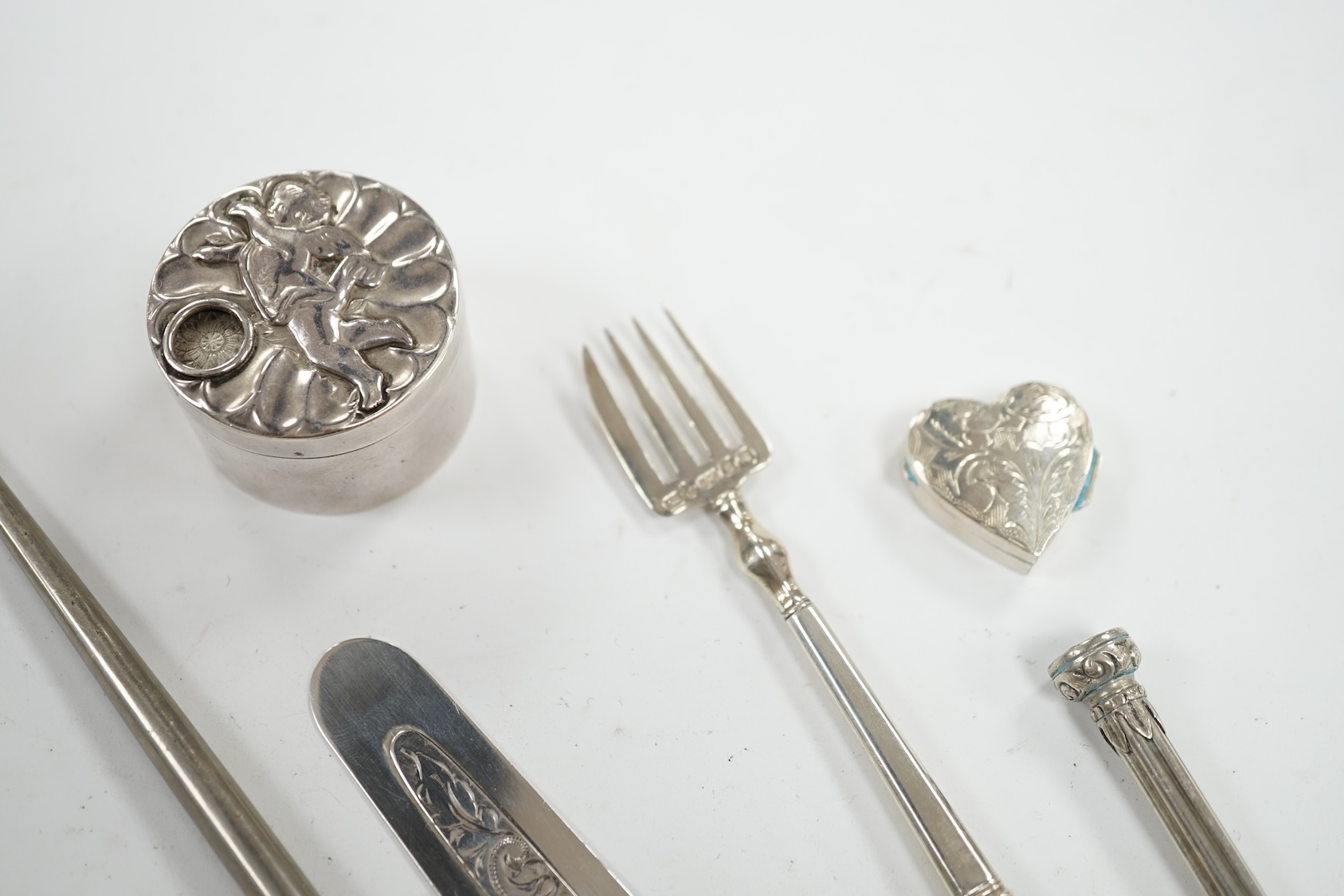 Small silver including a late Victorian slide action pill box, Birmingham, 1890, a heart shaped pill box, a book mark, pencil, pickle fork and a button hook